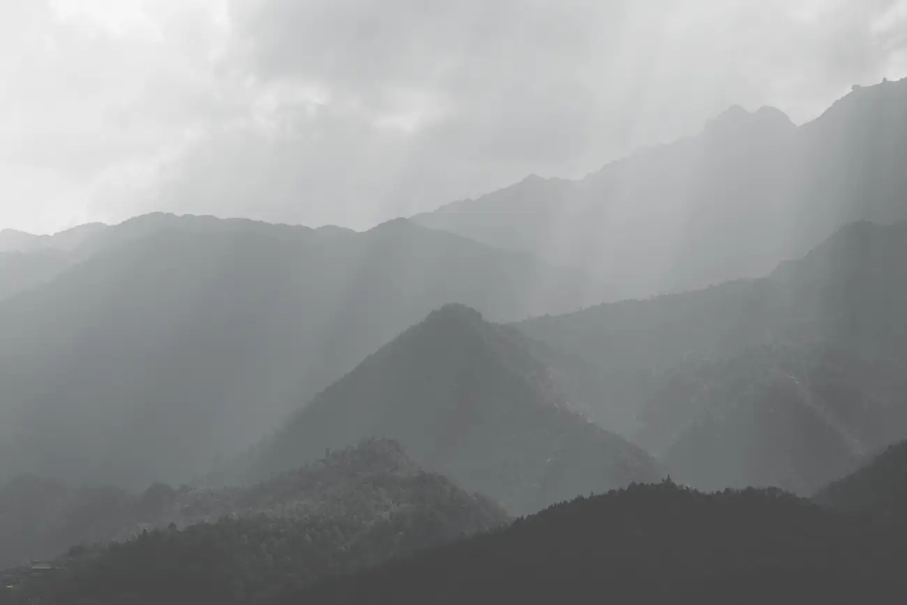 Layered mountain ridges in mist